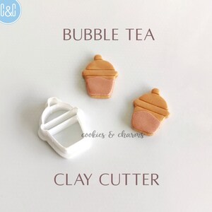May include: White plastic clay cutter shaped like a bubble tea cup. Two brown and gold bubble tea cups are shown next to the cutter. The text "BUBBLE TEA" and "CLAY CUTTER" are printed on the white background.
