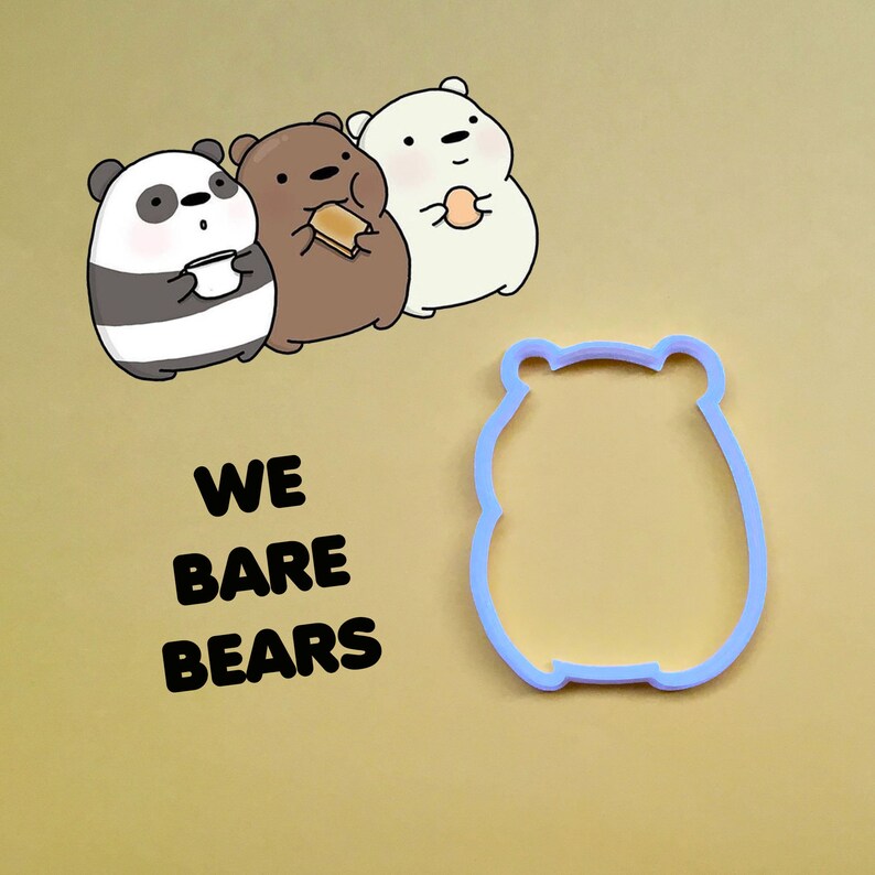 May include: A set of three We Bare Bears cookie cutters. The cutters are shaped like the three bears from the cartoon: Panda, Grizzly, and Ice Bear. The cutters are made of blue plastic and are on a light brown background.