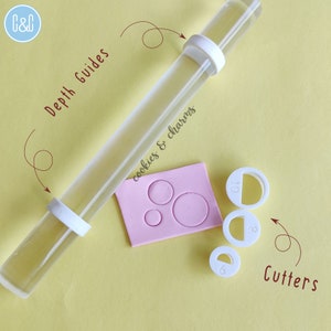 May include: A set of white plastic cookie cutters and rolling pin depth guides. The cutters are round and have numbers 6, 8, and 10 printed on them. The rolling pin guides are also round and fit onto a clear rolling pin. The text "Depth Guides" and "Cutters" are written on the image.