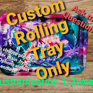 May include: A custom rolling tray with a colorful abstract design. The tray is made of resin and has a glossy finish. The text "Custom Rolling Tray Only" is written in yellow on the tray. The text "Ask me questions" is written in red on the top right corner of the tray. The text "You choose photos, glitter, plain, hydro dip. Options almost endless" is written in black on the bottom left corner of the tray. The text "Customization 1-2 weeks" is written in green at the bottom of the tray.