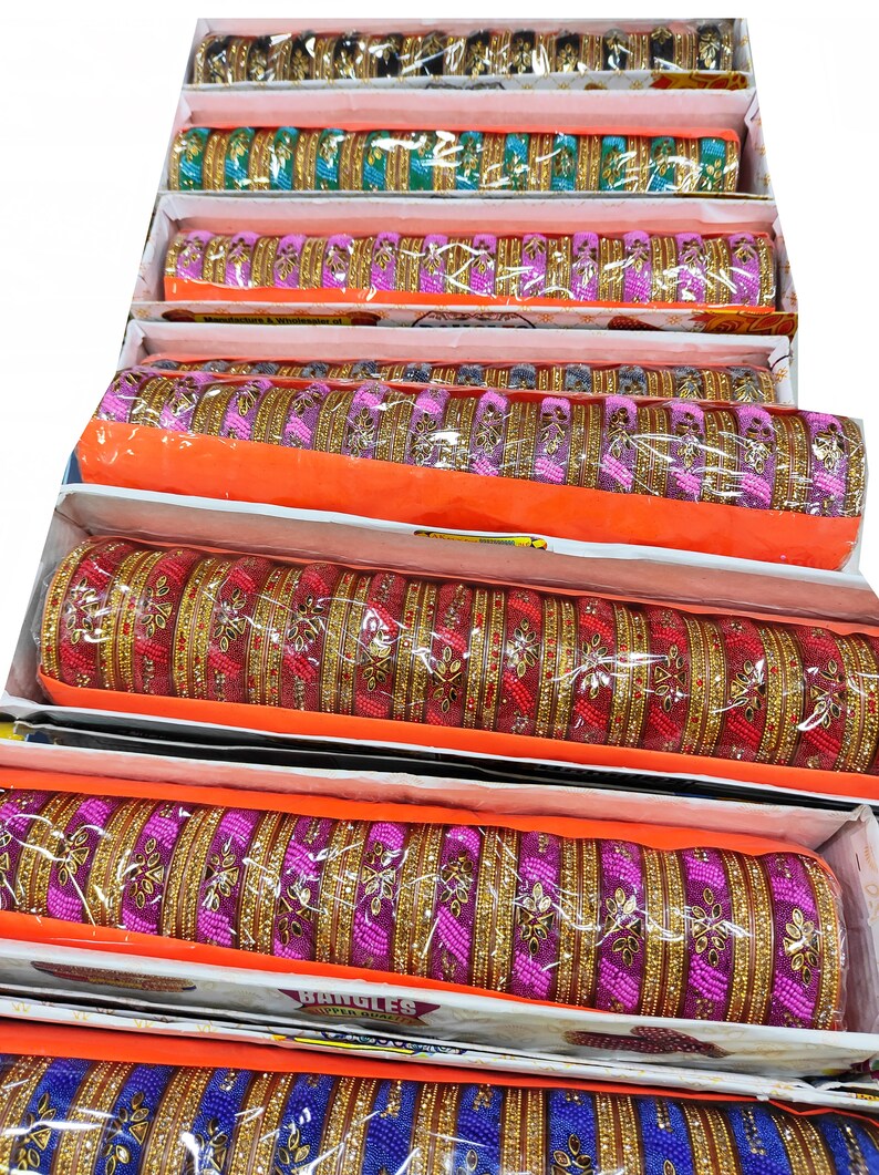 Puede incluir: Una pila de pulseras coloridas con detalles dorados. Las pulseras est&aacute;n dispuestas en cajas con tapas naranjas. Las cajas est&aacute;n etiquetadas con "Bangles Super Deal".