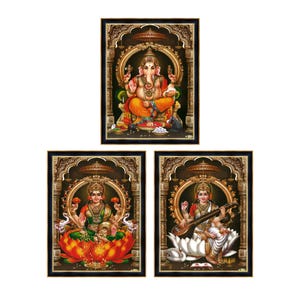 May include: Set of three framed Hindu deity prints. The top print features Ganesha in orange and yellow. The bottom prints depict Lakshmi and Saraswati, each in ornate frames with gold accents and dark backgrounds.