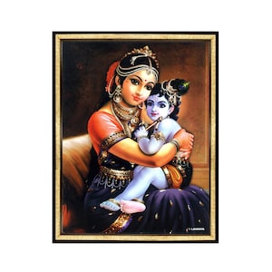 May include: A framed painting depicting a woman holding a young boy. The woman is wearing a purple and pink sari with gold jewelry. The boy is wearing a blue and yellow outfit and holding a flute. The painting is set against a dark brown background.