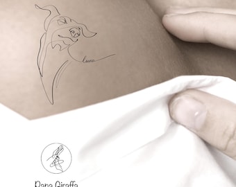 May include: A minimalist line drawing of a dog's head and face, with the name "Luna" in cursive. The image is a tattoo design. The Papa Giraffa logo is at the bottom, featuring a rabbit-like figure.