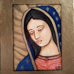 May include: A framed painting of a woman with dark hair and a blue veil adorned with gold stars. The woman is depicted with a serene expression, wearing a red garment. The artwork is set against a gold background.