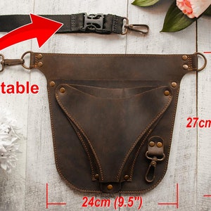 May include: Brown leather tool belt with an adjustable strap and multiple pockets. The belt measures 27 inches tall and 9.5 inches wide.