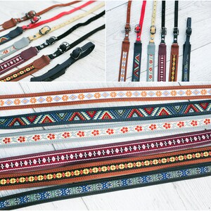 Puede incluir: Una colecci&oacute;n de correas de c&aacute;mara coloridas con patrones geom&eacute;tricos y florales. Las correas est&aacute;n hechas de tejido tejido y tienen longitudes ajustables.