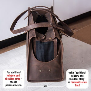 May include: Brown leather pet carrier with a mesh window and a zipped opening. The carrier has a top handle and a shoulder strap. The text "For additional window and shoulder strap - choose personalization" and "write "additional window and shoulder strap" in Personalization field" is visible on the image.