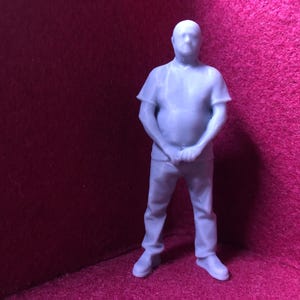 May include: A white ceramic mug with a black handle and the text "But First, Coffee" in a bold, black font. The mug is sitting on a wooden surface. The mug is approximately 4 inches tall.