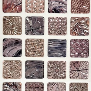 May include: A collection of twenty-four square tiles with various textured designs. The tiles feature patterns like swirls, waves, and geometric shapes, in shades of silver, brown, and purple. The overall aesthetic is artistic and decorative.