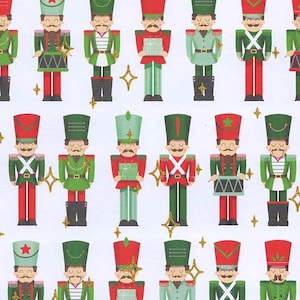 May include: A repeating pattern of toy soldiers in red, green, and gold on a white background. Each soldier is dressed in a uniform with a tall hat and a mustache. Some soldiers hold drums or gifts. Gold star accents are scattered throughout.