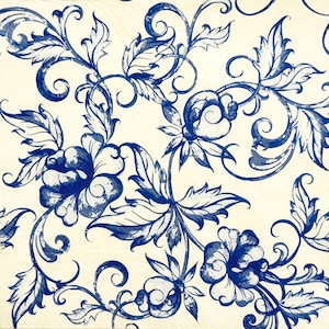 May include: A close-up of a cream-colored surface with a repeating pattern of blue floral and leaf designs. The pattern features stylized flowers, leaves, and swirling vines, creating a classic, decorative aesthetic.