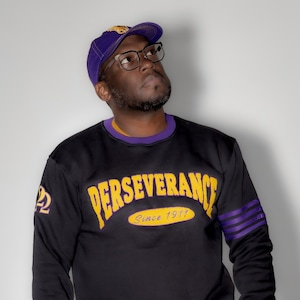Omega Psi Phi &quot;PERSEVERANCE&quot; Chenille Sweater Black
