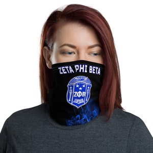 May include: A black face mask with a blue and white Zeta Phi Beta sorority crest and flames. The text "Zeta Phi Beta" is printed in white above the crest. The crest includes the letters "ZΦB" and the year "1920".