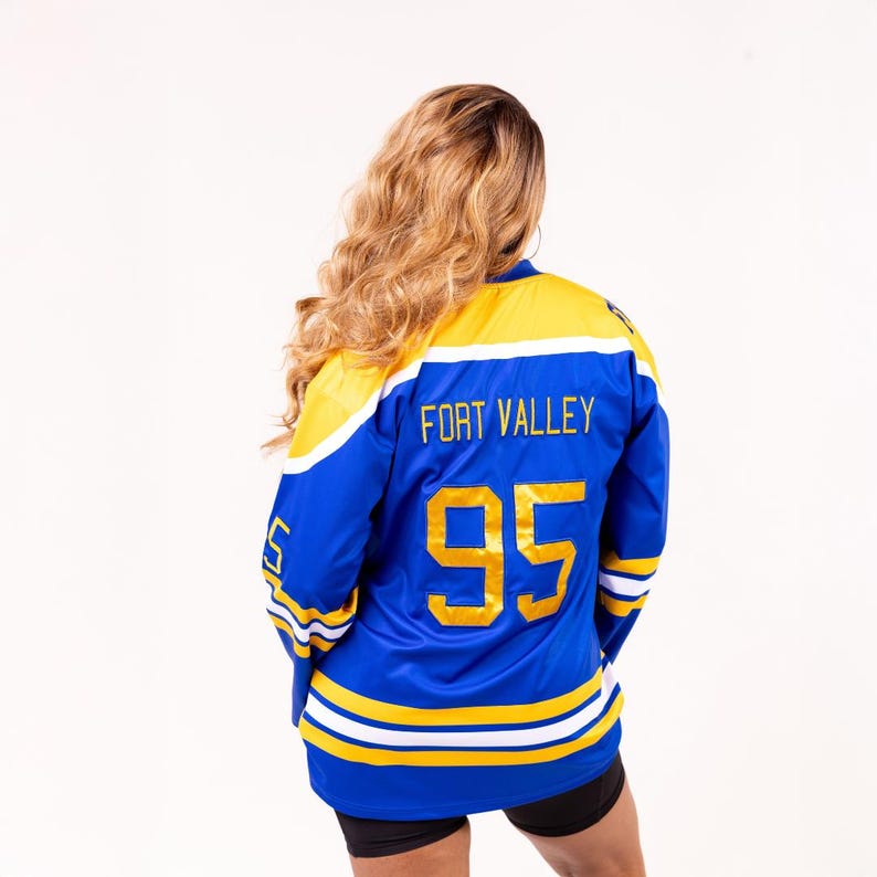 May include: Blue and yellow hockey jersey with the text "FORT VALLEY" and the number "95" on the back.