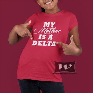 May include: Red t-shirt with white text that reads "My Mother is a Delta".