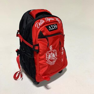 May include: A red and black rolling backpack featuring the embroidered text Delta Sigma Theta, the Greek letters &Delta;&Sigma;&Theta;, and a crest logo. The bag includes side mesh pockets, adjustable red straps, and a vertical 1913 print on the front panel.