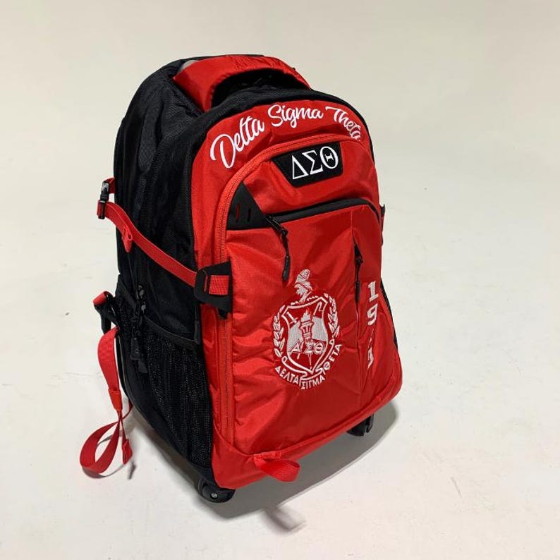 May include: A red and black rolling backpack featuring the embroidered text Delta Sigma Theta, the Greek letters &Delta;&Sigma;&Theta;, and a crest logo. The bag includes side mesh pockets, adjustable red straps, and a vertical 1913 print on the front panel.