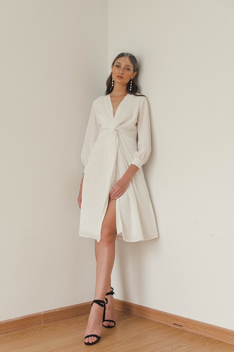 tea length white dress with sleeves