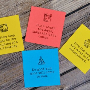 May include: Four yellow and blue sticky notes with inspirational quotes and doodles on a wooden surface. The quotes are: "A little step might be the beginning of a great journey." "Don't count the days, make the days count." "Do good and good will come to you." "Live the way you want to be remembered."
