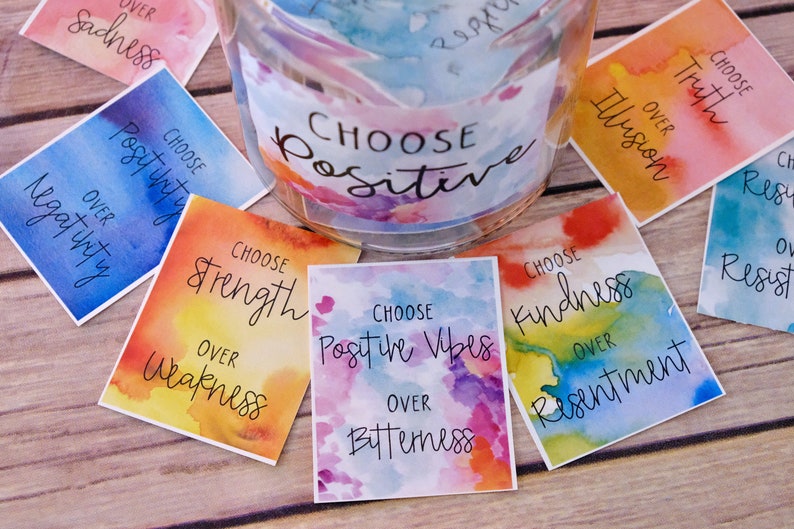 May include: A set of colourful cards with watercolour backgrounds and inspirational messages. Each card features the phrase "Choose" followed by a positive affirmation, such as "Choose Strength over Weakness" or "Choose Kindness over Resentment".