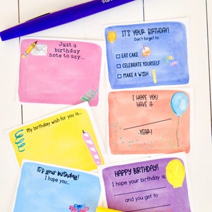 May include: Five watercolor birthday cards with different designs. The cards are all rectangular and have a white border. The designs include a birthday cake, a balloon, a candle, a gift, and a pencil and envelope. The cards are all blank inside for writing a message.