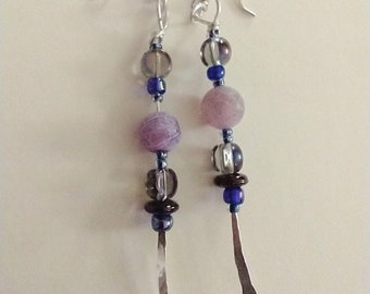 Earrings made with Hammered silver with purple frosted glass beads and lavender flat disc glass beads attached.