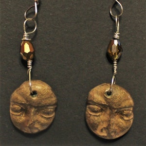 Hand formed polymer clay face earrings accented with crystal cut brown glass beads