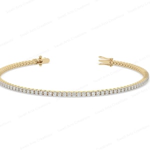 May include: A gold bracelet featuring a line of small diamonds. The bracelet is displayed against a white backdrop, with the clasp open. The jewellery is a classic design, suitable for everyday wear or special occasions.