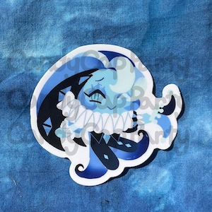 May include: A die-cut sticker featuring a cartoon character with a light blue face, a white ruffled collar, and a dark blue cape. The character has a mustache and is surrounded by light and dark blue accents. The sticker is on a blue background.