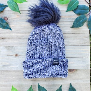 Berretto lavorato a maglia bianco e nero con pompon in pelliccia sintetica nera, cappello invernale lavorato a maglia, berretto lavorato a maglia con tesa piegata