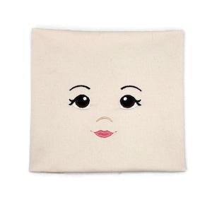 Embroidered face for rag doll.
