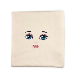 Embroidered face for rag doll.