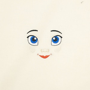 Embroidered face for rag doll.