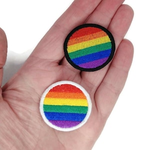 May include: Two embroidered rainbow patches, one with a black border and one with a white border. The patches are circular and feature the colors of the rainbow.