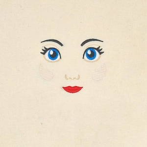 Embroidered rag doll face.