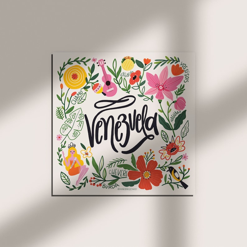 May include: A square print featuring the word "Venezuela" in black script, surrounded by colorful illustrations. The design includes flowers, a pink ukulele, a bird, and a cartoon figure, all set against a white background.