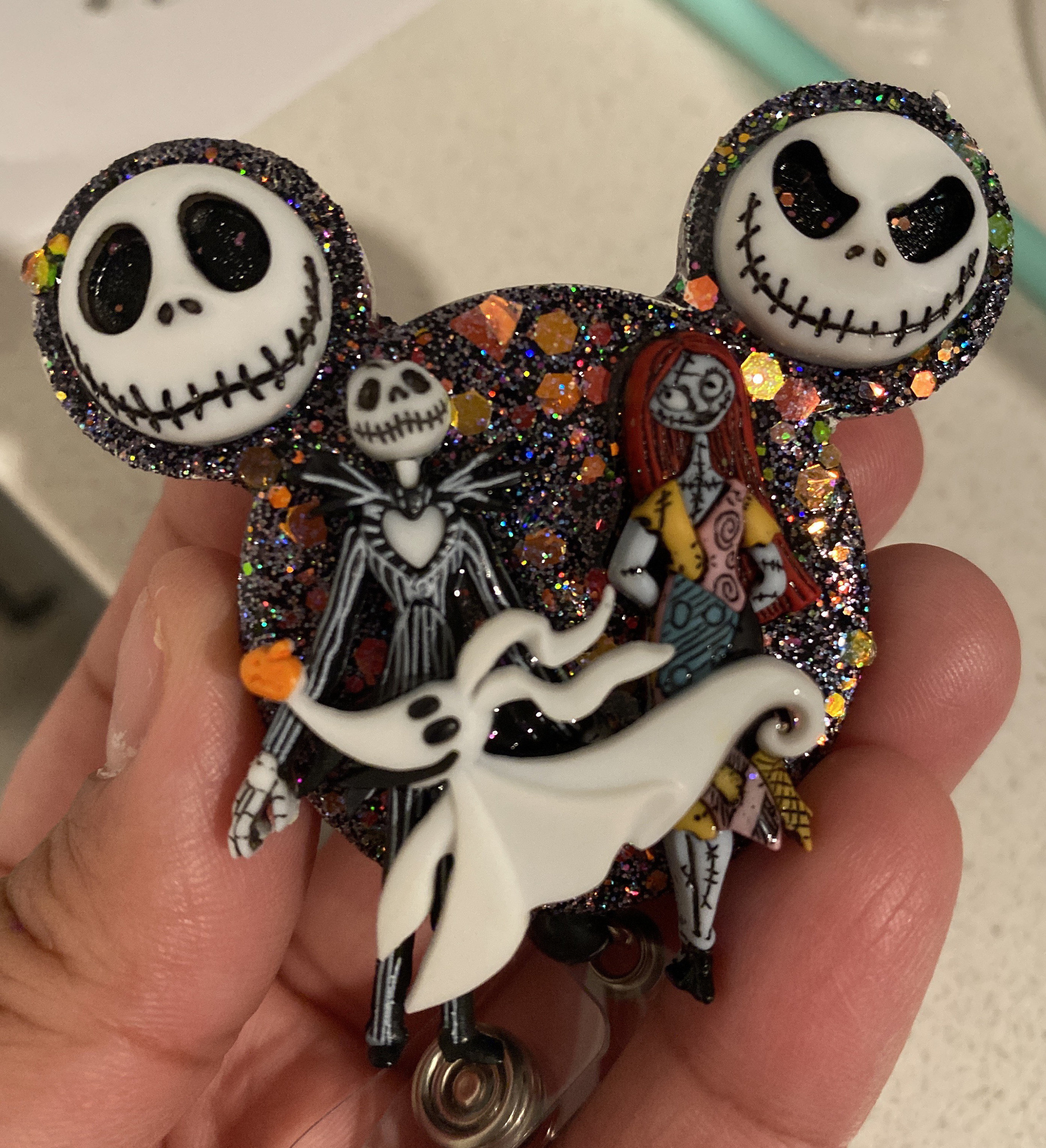 The Nightmare before Christmas jack and sally with zero badge reel.  Alligator/ belt clip available