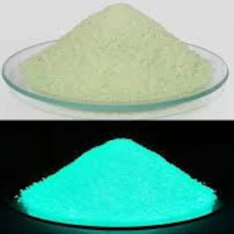 May include: A pile of bright green glow-in-the-dark powder. The powder is illuminated by a blacklight, showing its vibrant green glow.