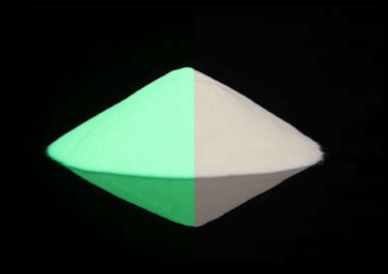 May include: A pile of glow-in-the-dark powder, shown in both its normal and glowing states. The powder is a bright green color when exposed to a black light.