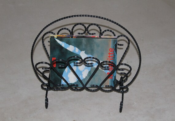 MAGAZINE RACK, iridescent satin black twisted wrought iron magazine rack, 1960s.