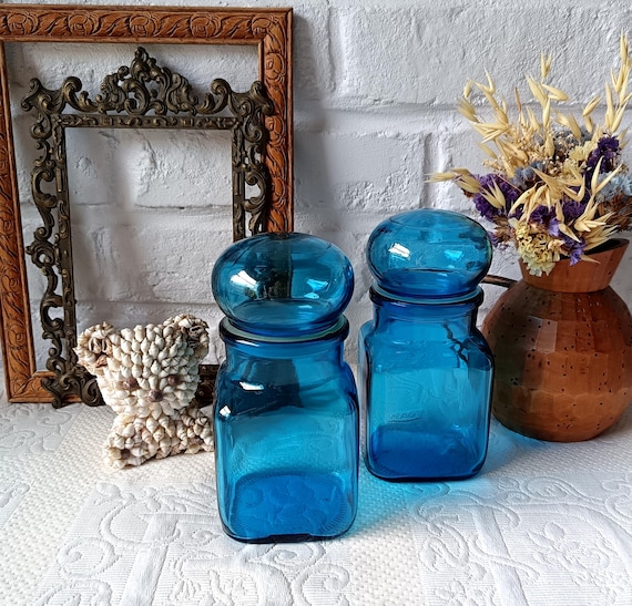 2 turquoise blue glass jars, jar with airtight bulbous lid, lever, vintage