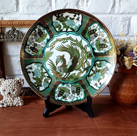 Asian-inspired porcelain plate with peacock, peony, and butterfly decoration