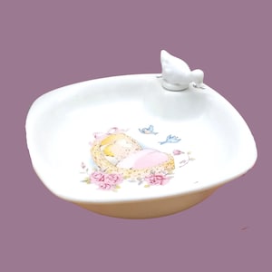 Vintage porcelain baby warming plate, little girl in her bassinet motif