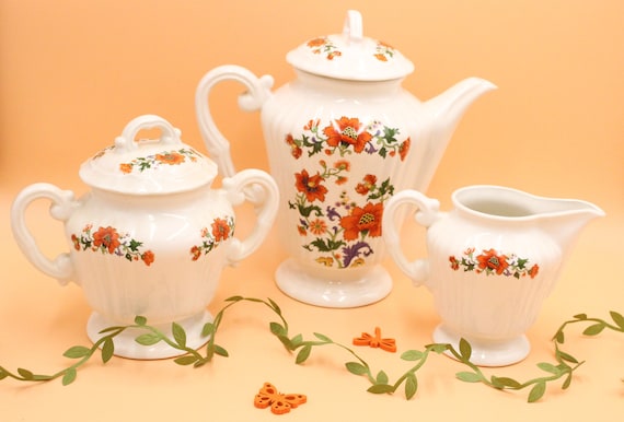 Coffee pot, sugar bowl and creamer with orange floral decoration, Orchies-Moulin des Loups model, Chenonceau, France