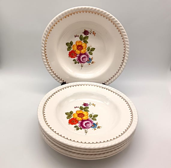 Antique hollow plates from Keller et Guerin (K&G) earthenware factory in Lunéville, France, with a bouquet of flowers motif