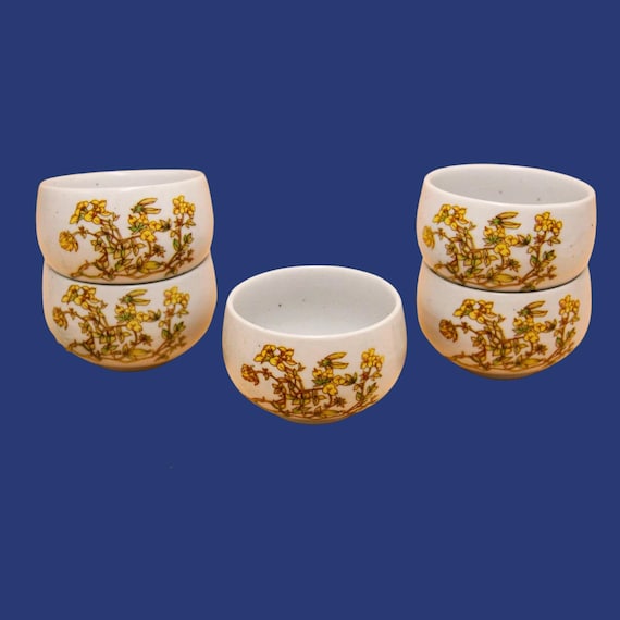 5 Asian-style white ceramic tea cups with floral pattern, 1980