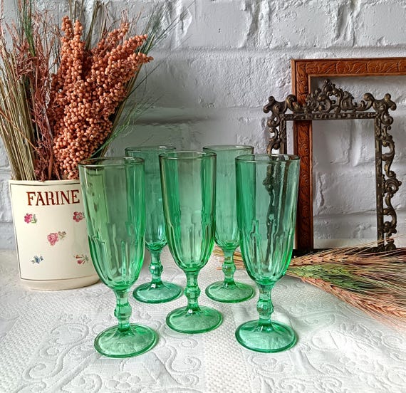 5 vintage champagne flutes in emerald green colored glass