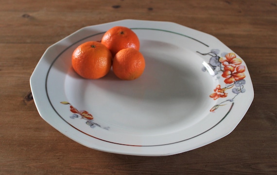 Round serving dish with orange and gray nasturtium floral pattern