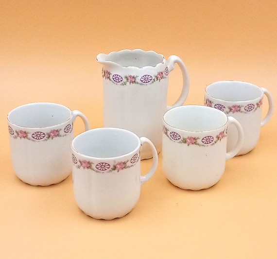 4 porcelain cups and creamer with vintage floral pattern